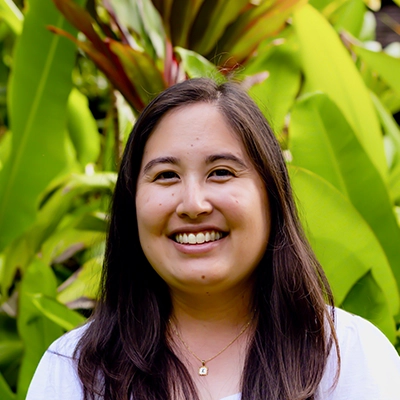 Dental Hygienist Lisa Smiling In Front Of Greenery