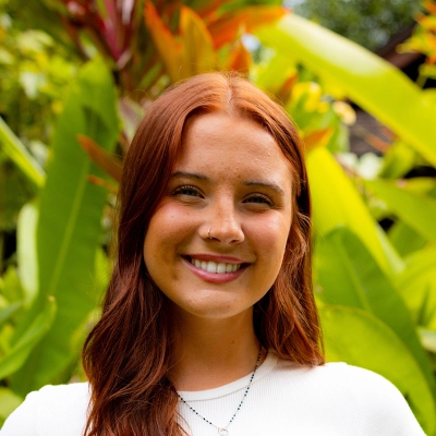 Dental Hygienist Molly Smiling In Front Of Greenery